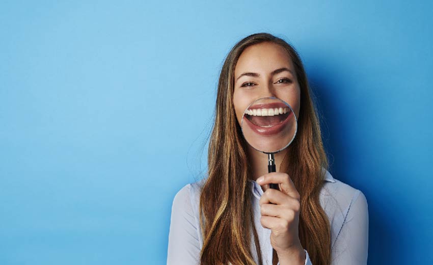 woman large smile magnifying glass