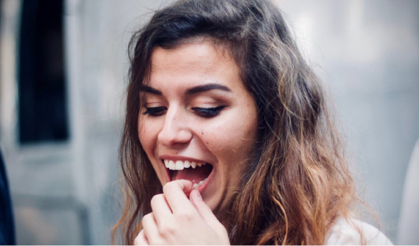 girl holding her tooth because a filling fell out