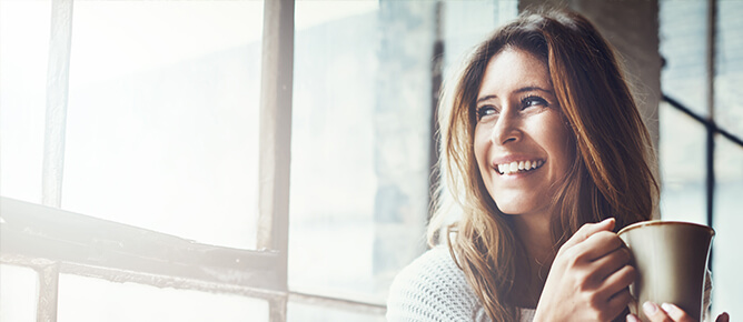 Woman smiling looking out window