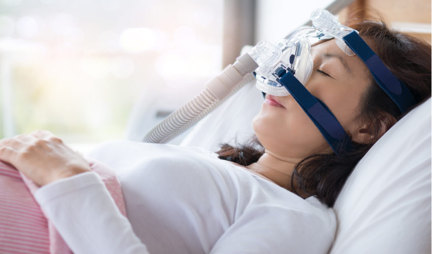 young woman in the dentist's chair undergoing sedation dentistry to ease dental anxiety