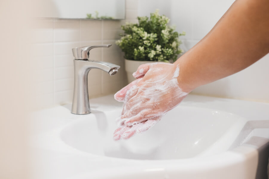 Closeup image of person washing their hands to protect themselves from coronavirus