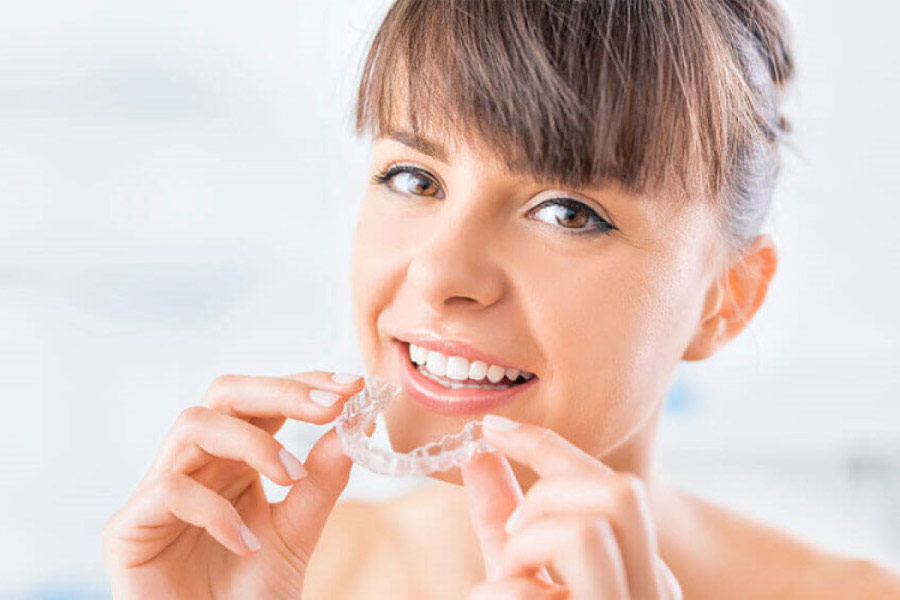 woman inserting a clear aligner