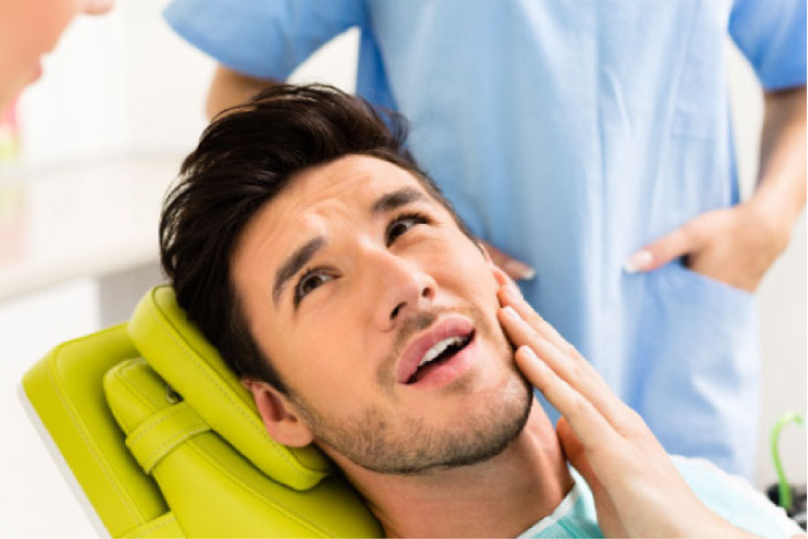 young man in the dentist chair getting ready for a tooth extraction