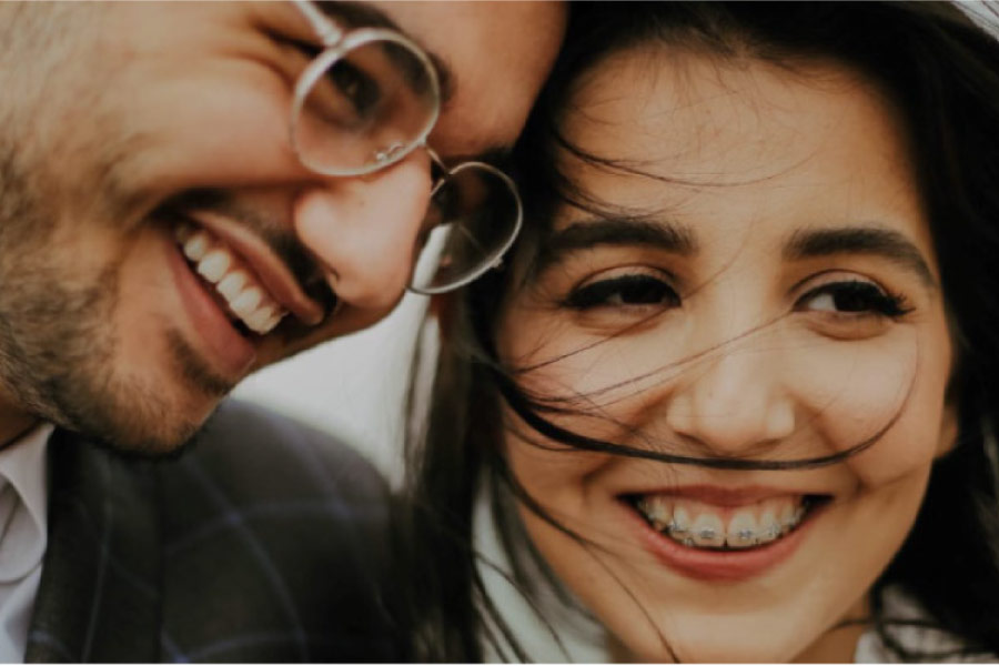 young couple smile showing results of braces vs invisalign