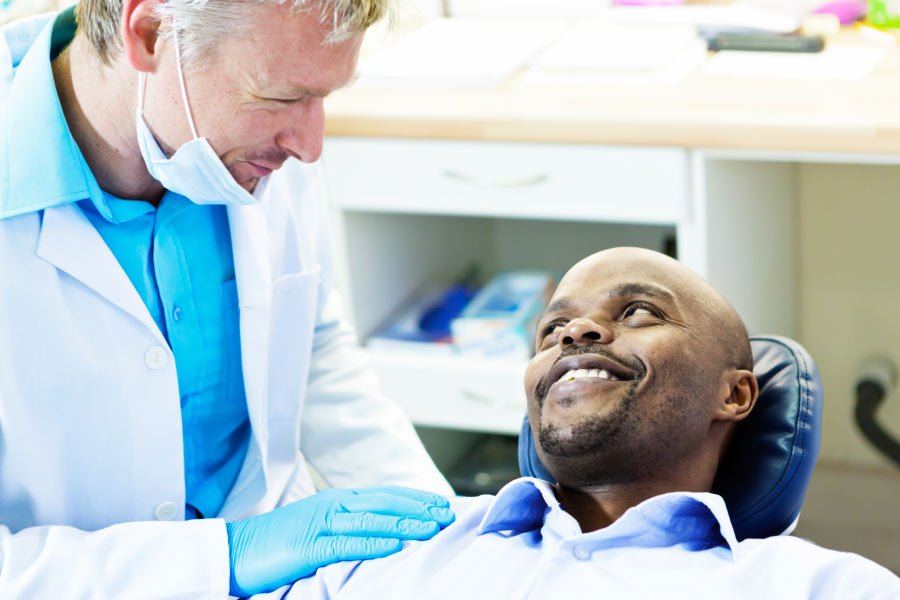 male dental patient discusses gum disease with the dentist